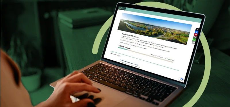 Person typing on a laptop displaying a MonkeyPod nonprofit fundraising page